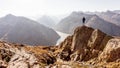 Hiker or alpinist at the top of a mountain.