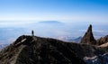 Hiker ascending top of volcanic mountain