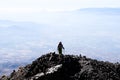 Hiker ascending top of volcanic mountain