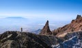 Hiker ascending top of volcanic mountain