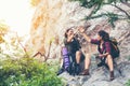 Hiker asian two women shake hand and pointing happy feeling freedom good and strong weight victorious facing on the natural mounta