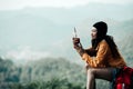 Hiker asian woman sitting and drinking coffee for relax and rest on mountain. Female adventure backpack and trips camping on hike