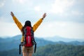 Hiker asian women raise hand and pointing happy feeling freedom good and strong weight victorious facing on the natural mountain. Royalty Free Stock Photo