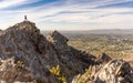 Hiker atop Piestewa Peak in Phoenix, Arizona overlooking desert and rocky cliffs on a hot bright day