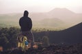 Hiker with backpack enjoying sunset on old volcanic cone in Etna Park