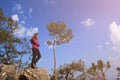 Hiker with backpack enjoying valley view from top of mountain. Royalty Free Stock Photo