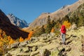 Hiker with backpack enjoying view in the autumnal mountains. Mountain and woman Royalty Free Stock Photo