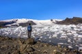 Hiker with backpack in front of Fjallsarlon Lagoon and VatnajÃÂ¶kull Glacier, Sudurland, Iceland