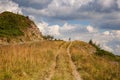 Hiker with backpack going uphill. Hiker going up to the mountain peak on a very steep trail Royalty Free Stock Photo