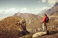 Hiker with backpack looks at the beautiful mountains in Upper Mu