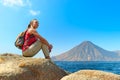 Hiker with backpack relaxing on a rock