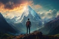 Hiker with backpack standing on the edge of the cliff and looking at the mountain peak, A young man looking at a big beautiful Royalty Free Stock Photo