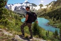 Hiker with backpack standing on a hillside