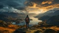 Hiker with backpack standing on top of a mountain and looking at the lake Royalty Free Stock Photo