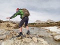 Hiker with backpack traveling in spring Dolomiti