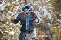 Hiker with backpack trekking in mountains. Cold weather, snow on