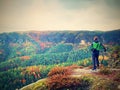 Hiker backpacker reaches the summit of mountain peak. Success, freedom and happiness Royalty Free Stock Photo