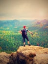 Hiker backpacker reaches the summit of mountain peak. Success, freedom and happiness Royalty Free Stock Photo