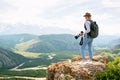 Hiker with backpacks enjoying valley view.