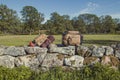 Hiker backpacks on limestone fence landscape photo