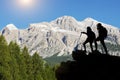 Hiker with backpacks reaches the summit of mountain peak. Success, freedom and happiness, Achievement in mountains. Active sport c Royalty Free Stock Photo