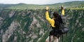 Hiker with backpacks reaches the summit of mountain peak. Success, freedom and happiness concept Royalty Free Stock Photo