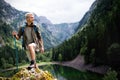 Hiker with backpacks reaches the summit of mountain peak. Success, freedom and happiness concept Royalty Free Stock Photo