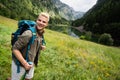 Hiker with backpacks reaches the summit of mountain peak. Success, freedom and happiness concept Royalty Free Stock Photo