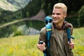 Hiker with backpacks reaches the summit of mountain peak. Success, freedom and happiness concept Royalty Free Stock Photo