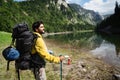 Hiker with backpacks reaches the summit of mountain peak. Success, freedom and happiness concept Royalty Free Stock Photo