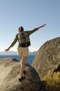 Hiker Balancing On Boulder At Coast