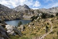 Hiker in a beautiful landscape of the natural park of Aigestortes y Estany de Sant Maurici, Pyrenees valley with river and lake Royalty Free Stock Photo