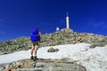 Hiker with big traveling rucksack looking forward on the mountain trail Royalty Free Stock Photo