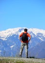 hiker with black backpack on shoulders before the big trek towards snow-capped mountains Royalty Free Stock Photo