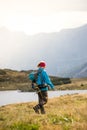 Hiker in boots and with backpack is walking un the upland, Austria