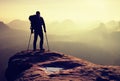 Hiker with broken leg in immobilizer. Deep misty valley bellow silhouette Royalty Free Stock Photo