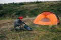 Hiker or camper sets up tent in epic scenery