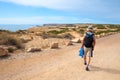 Hiker on ccoastal road near Carrapateira, dune landscape West Algarve Portugal