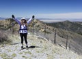 A Hiker Celebrates Reaching the Summit of a Mountain