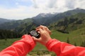 hiker checking the altimeter on sports watch at mountain peak Royalty Free Stock Photo