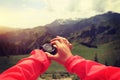 Hiker checking the altimeter on sports watch at mountain peak Royalty Free Stock Photo