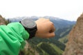 Hiker checking the altimeter on sports watch at mountain peak Royalty Free Stock Photo