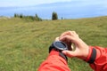 Hiker checking the altimeter on sports watch at mountain peak Royalty Free Stock Photo