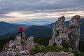 Hiker climbing high mountain rocks