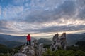 hiker climbing high mountain rocks