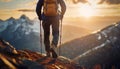 Hiker climbing mountains and reaching the top. Male hiking and overcoming obstacles as ascends the rocky peaks. Leader success and Royalty Free Stock Photo