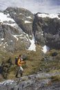 Hiker Climbing Trail In Steep Mountains