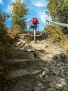 Hiker climbing up steep tourist trail to Wielka Racza, Beskid Zywiecki, Poland