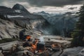 hiker cooking meal over campfire, with view of the mountain range in the distance