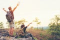 Hiker couple backpack enjoy happy and sitting happy feeling freedom good and strong weight victorious facing on the natural mounta